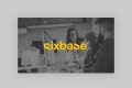 A group of people working together at computers in an office, with a woman standing and smiling at seated colleagues. The word sixbase in bold yellow text is centered over the image.