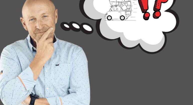 A bald man in a light blue shirt stands thinking, with a hand on his chin. A thought bubble above him shows a sketched car, red exclamation and question marks, and symbols of confusion.