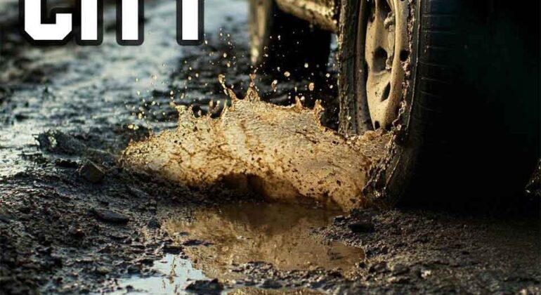 A muddy car tire splashes through a large puddle on a rough, potholed road. The bold words CRATER CITY appear in the upper left corner.