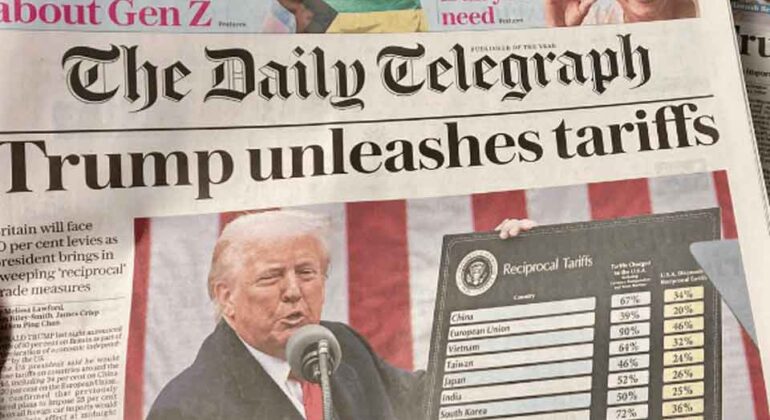 A newspaper front page shows Donald Trump speaking at a podium with a chart of Reciprocal Tariffs beside him. The headline reads, Trump unleashes tariffs. Other newspapers are partially visible underneath.