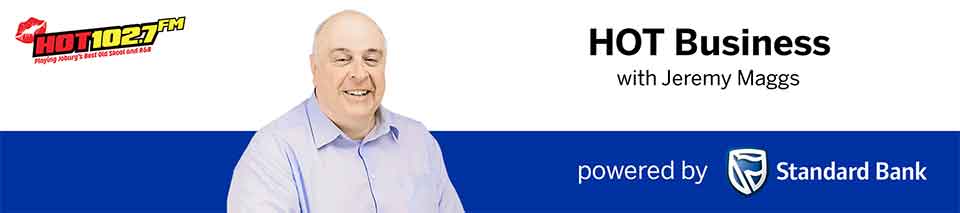 Banner for HOT Business on HOT1027 FM, featuring a smiling bald man in a light shirt, with text HOT Business with Jeremy Maggs, and powered by Standard Bank with the banks logo.