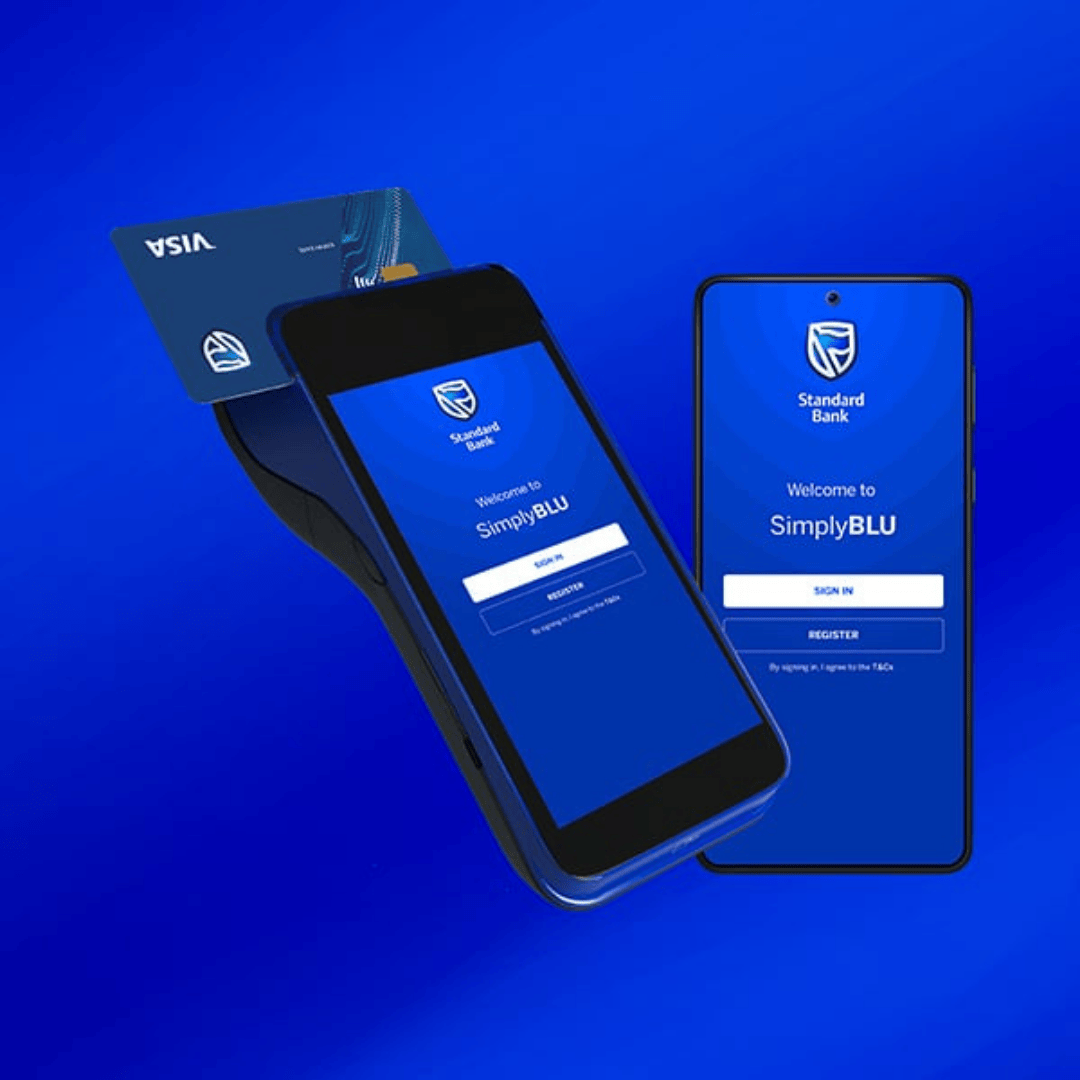 A Visa card is tapped on a payment terminal displaying the Standard Bank SimplyBLU app, next to a smartphone also showing the same apps login screen, all set against a blue background.