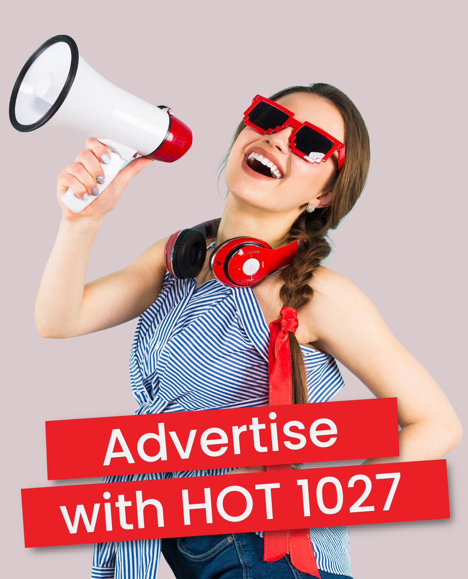 A smiling woman wearing red sunglasses and headphones holds a megaphone. Red banners with white text read: Advertise with HOT 1027 on a light gray background.