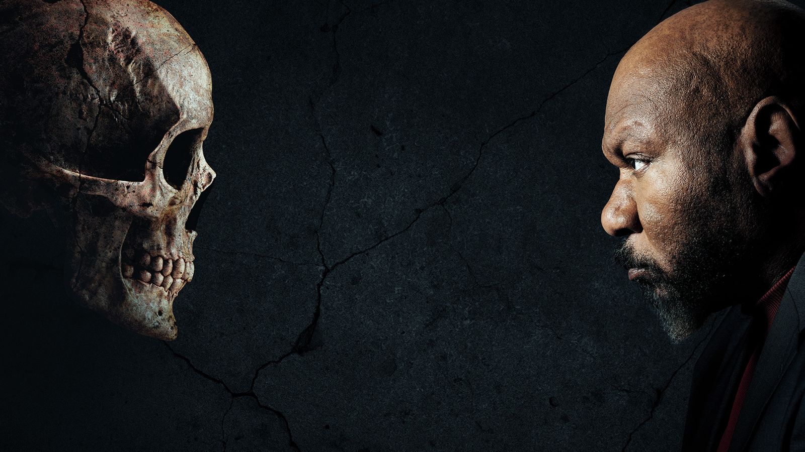 A man with a serious expression faces a human skull against a dark, cracked background, both in profile and staring intently at each other.